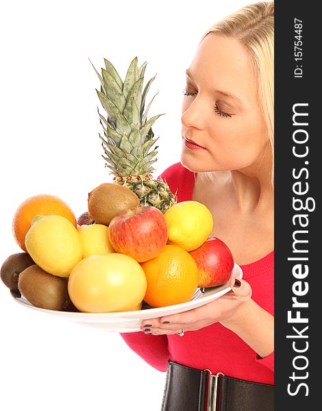 Young blond woman holding a plate with different fresh fruits. Young blond woman holding a plate with different fresh fruits