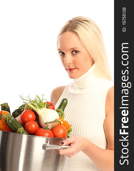 Young blond woman holding some different fresh vegetables. Young blond woman holding some different fresh vegetables