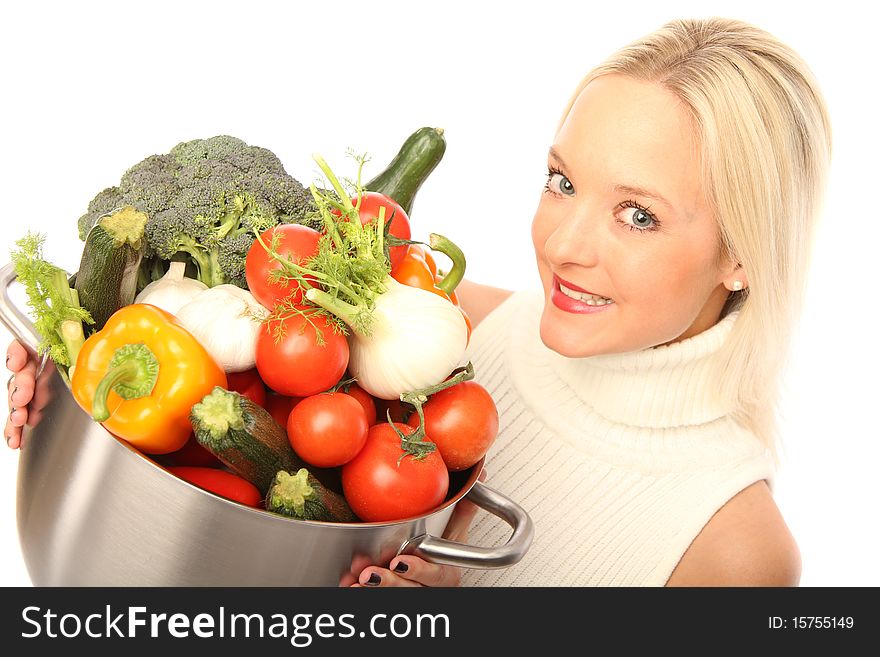 Young blond woman holding some different fresh vegetables. Young blond woman holding some different fresh vegetables