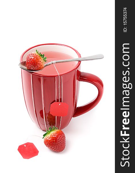 Big cup of fruit tea with strawberries as teabags, isolated on white