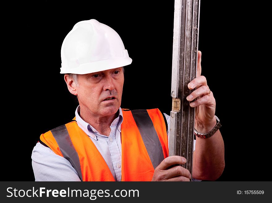 An engineer examining a spirit level. An engineer examining a spirit level