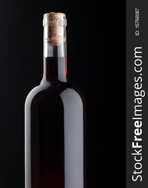Winebottle with red wine on black background. Winebottle with red wine on black background.