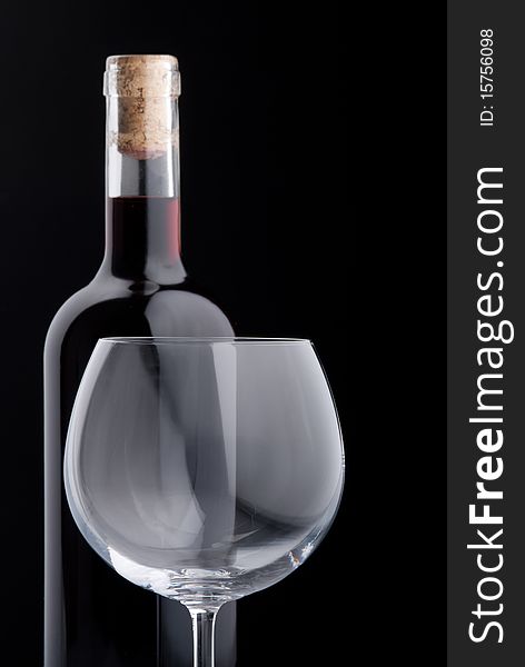 Elegant red wine and wineglass on black background. Elegant red wine and wineglass on black background.