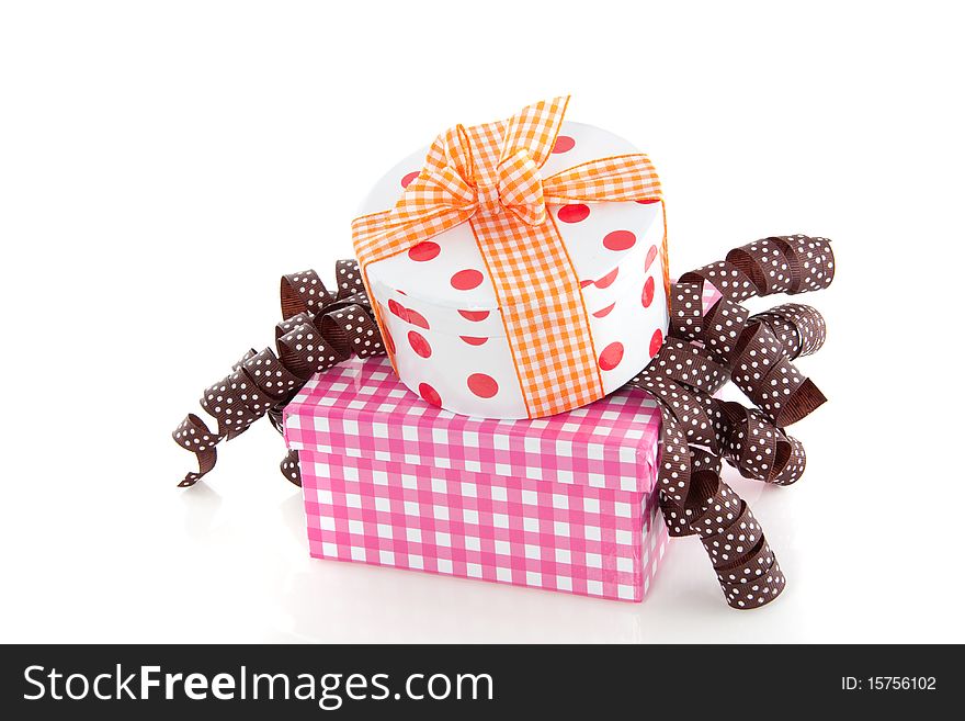 Colorful dotted and checkered giftboxes with ribbons isolated over white. Colorful dotted and checkered giftboxes with ribbons isolated over white