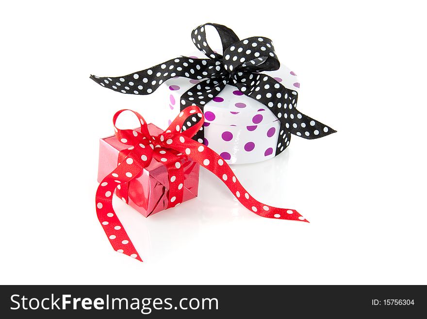 Colorfully dotted gifts with ribbons and bows isolated over white