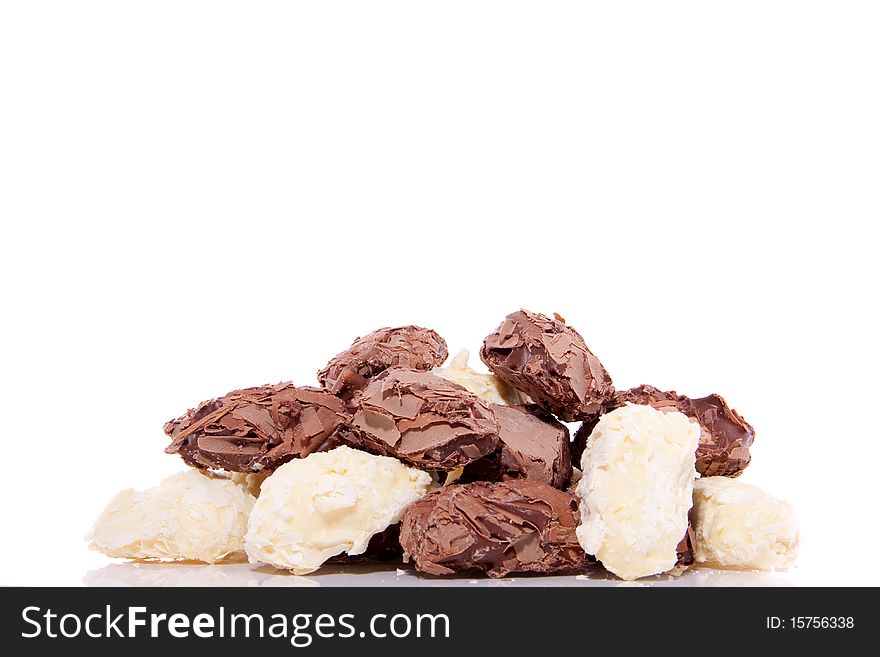 Delisiously brown and white chocolate truffles isolated over white