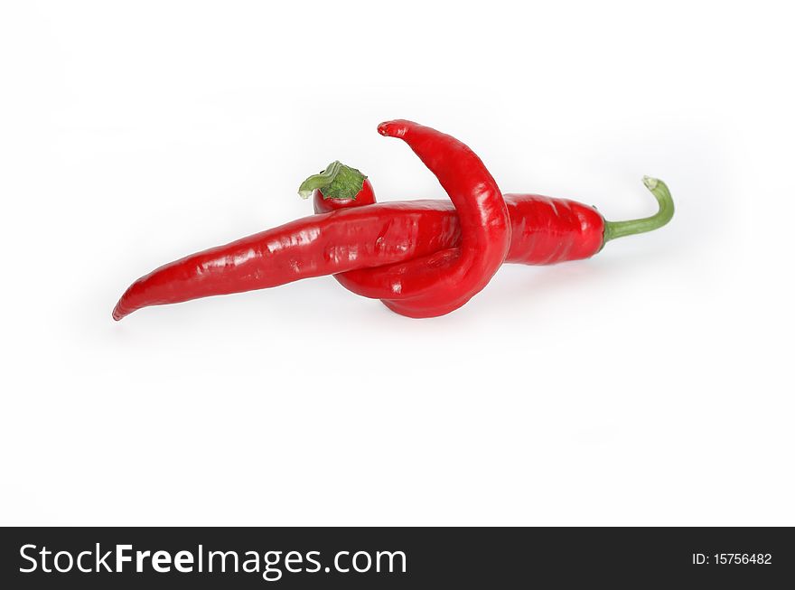 Two red chili peppers isolated on white background. Clipping path is included. Two red chili peppers isolated on white background. Clipping path is included