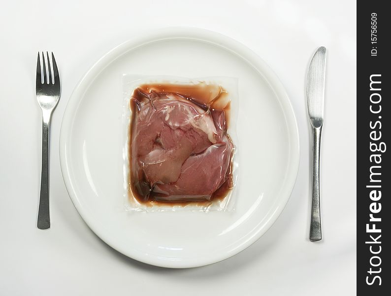 Vacuum packed meat on a plate. Vacuum packed meat on a plate