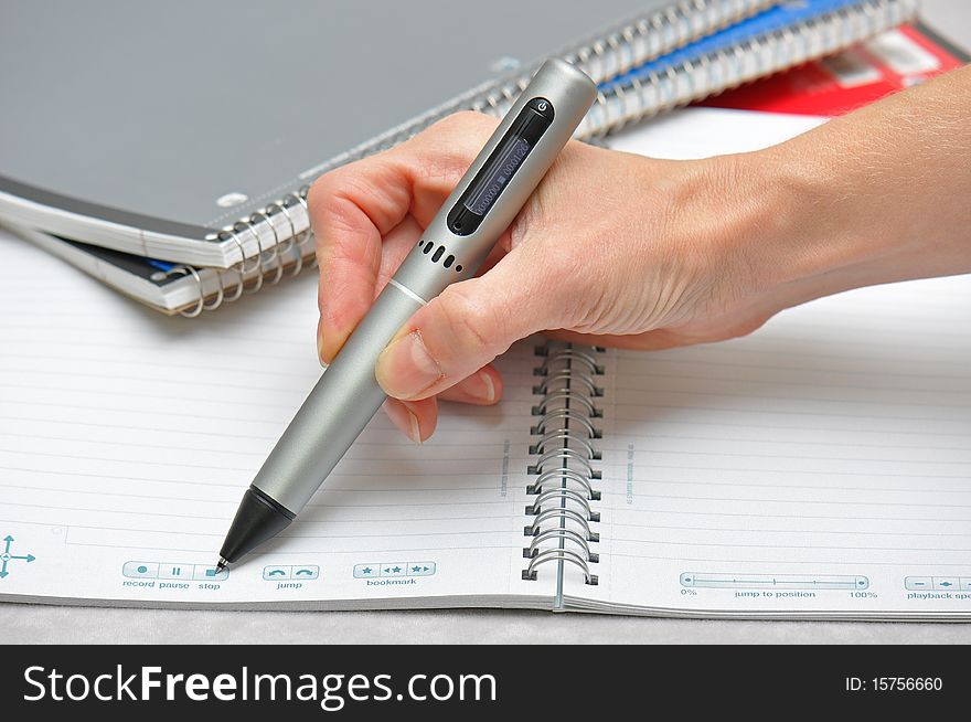 Ready to take notes with pen to paper in this pic of hand holding pen on notebooks. Ready to take notes with pen to paper in this pic of hand holding pen on notebooks