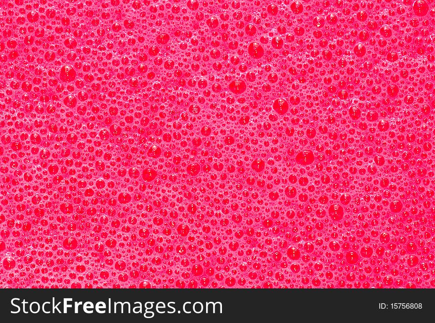 Bubbles formed in freshly mixed red dye. Bubbles formed in freshly mixed red dye