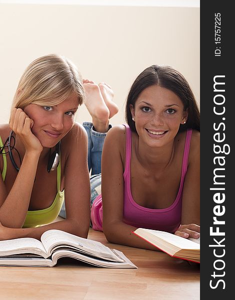 Happy teenage girls studying on the floor. Happy teenage girls studying on the floor