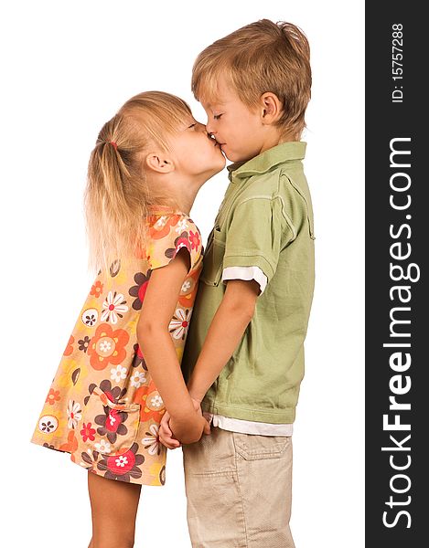 Little boy with girl isolated on white background. Friendly kiss.