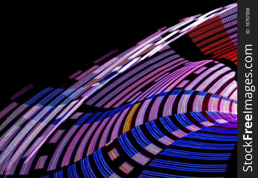 Spinning lights of a carnival ride.