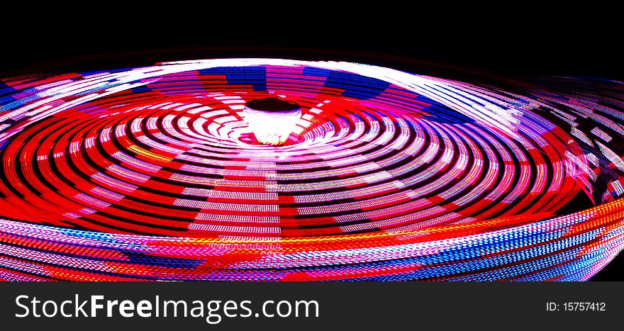 Spinning lights of a carnival ride.