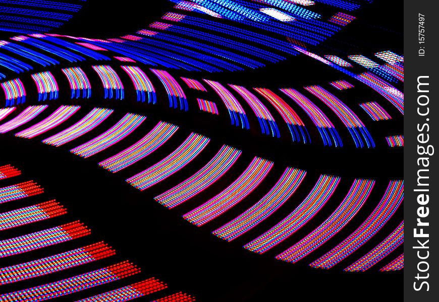 Spinning lights of a carnival ride.