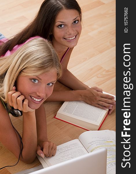 Happy teenage girls studying on the floor. Happy teenage girls studying on the floor