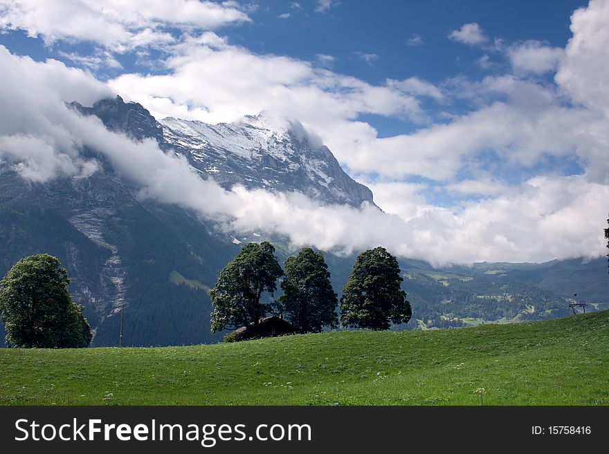 Green Swiss mountains with clouds. Green Swiss mountains with clouds