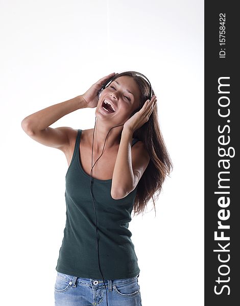 Beautiful teenage girl listening to muscic and singing. Beautiful teenage girl listening to muscic and singing