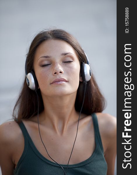 Beautiful teenage girl listening to muscic and relaxing. Beautiful teenage girl listening to muscic and relaxing