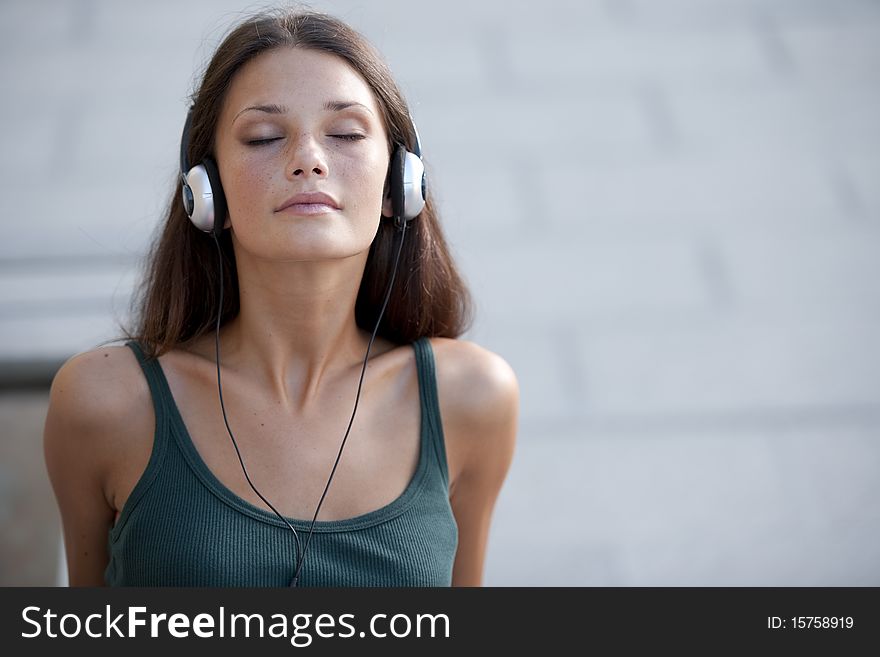 Beautiful teenage girl listening to muscic and relaxing. Beautiful teenage girl listening to muscic and relaxing