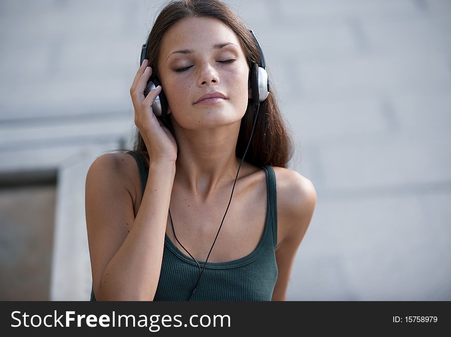 Beautiful teenage girl listening to muscic and relaxing. Beautiful teenage girl listening to muscic and relaxing