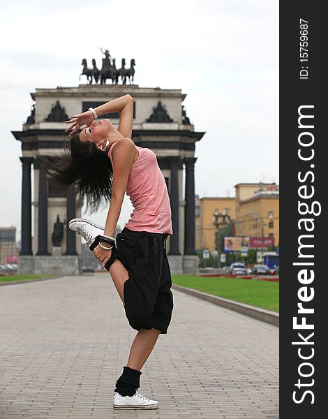 Woman modern ballet dancer in sity against classic arch. Woman modern ballet dancer in sity against classic arch