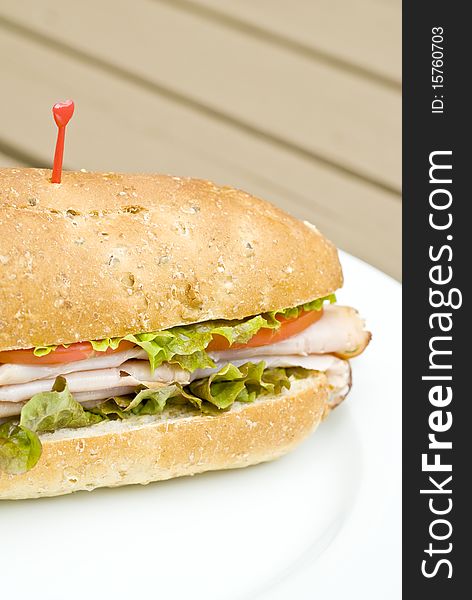 A turkey sandwich with tomato slices and lettuce. A turkey sandwich with tomato slices and lettuce.