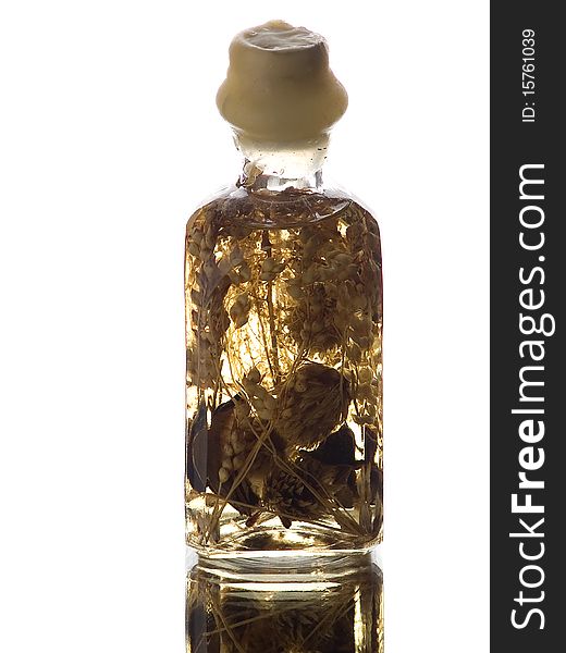 The photo shows a small bottle filled with bathoil over a mirror