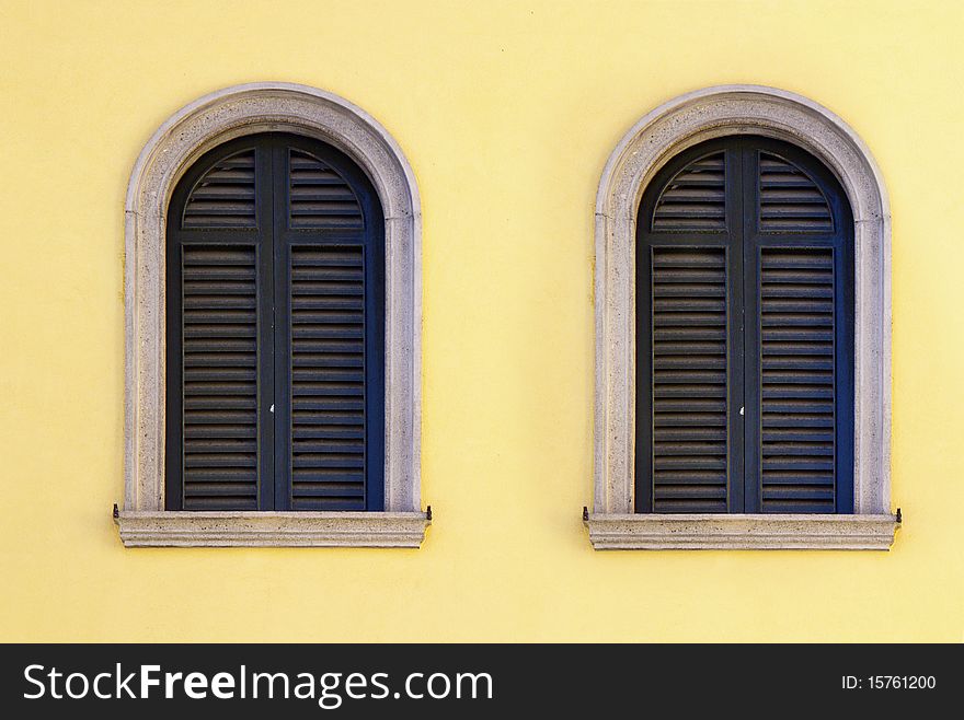 Windows closed on a yellow wall