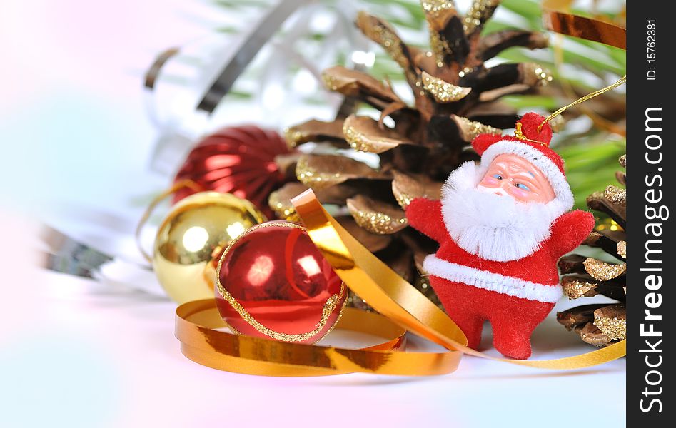 Christmas ornaments and Santa near the Christmas tree and cones. Christmas ornaments and Santa near the Christmas tree and cones