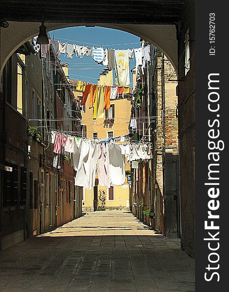 View of backstreet with drying clothes between houses in Venice, Italy