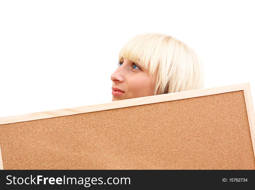 An attractive young woman with blue eyes meditating behind a corkboard. An attractive young woman with blue eyes meditating behind a corkboard