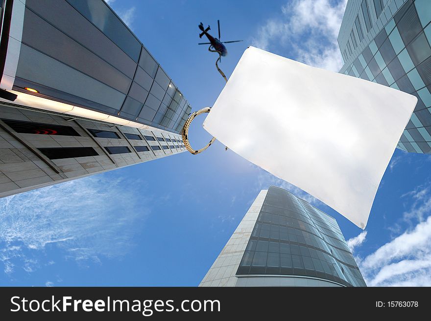 A Picture Of Blu Sky Over Skyscrapers And Chopper