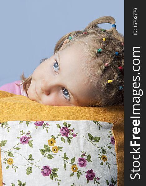 Cute caucasian blond little girl preparing to go to sleep having her decorated pillow near and looking appear with calm look isolated. Cute caucasian blond little girl preparing to go to sleep having her decorated pillow near and looking appear with calm look isolated