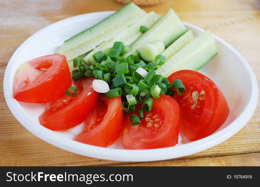 Frech cut vegetables on the plate with green onion. Frech cut vegetables on the plate with green onion.