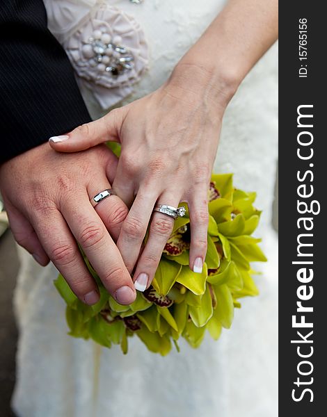 Wedding couple with rings and bouquet