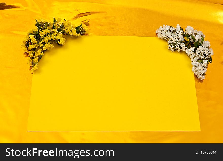 Yellow greeting card with flowers on yellow background