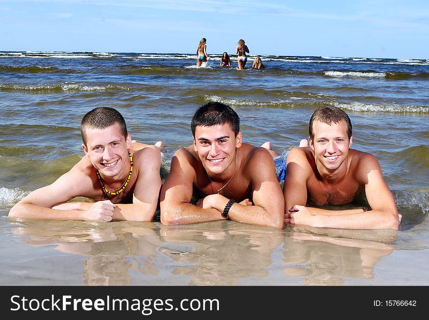 Happy teenagers playing in the sea