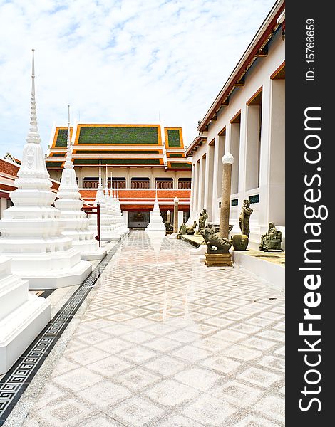 White pagoda in thai temple and refliction on ground