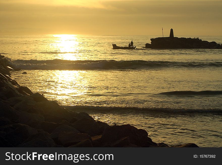 Silhouette Of A Fishing Boat Leaving The Harbour
