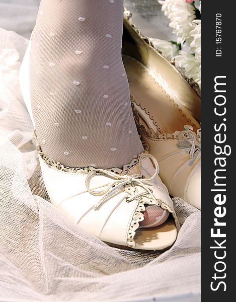 Bride puttting on wedding shoes