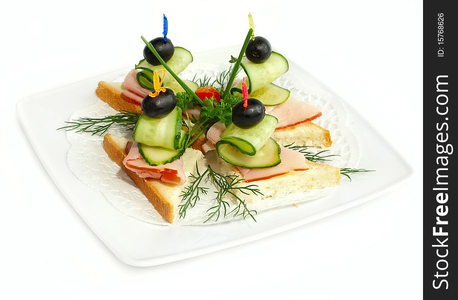 Canape with ham, cucumbers and olive. Canape with ham, cucumbers and olive