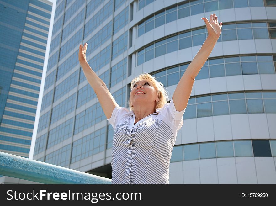 Business Woman Standing Against A Background Of Buildings