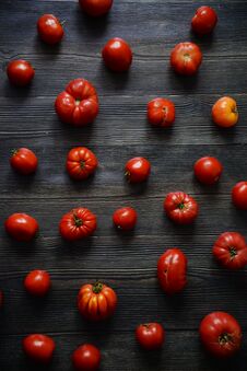 Tomatoes On The Old Table. Red Food Background. Tomatoes Pattern. Top View Of Fresh Vegetable On A Dark Wooden Royalty Free Stock Photography