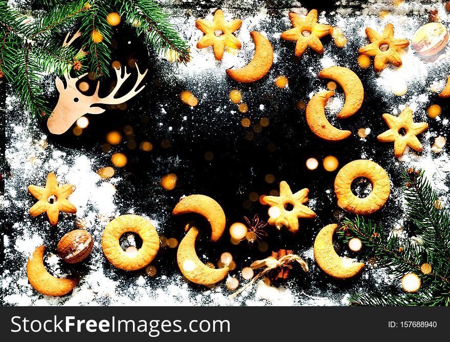 Christmas background. Festive cookies on black background. Blurred  effect. Close-up,copy space