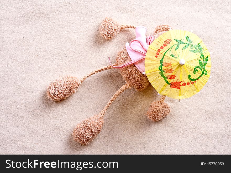 Plush toy under the beach umbrella