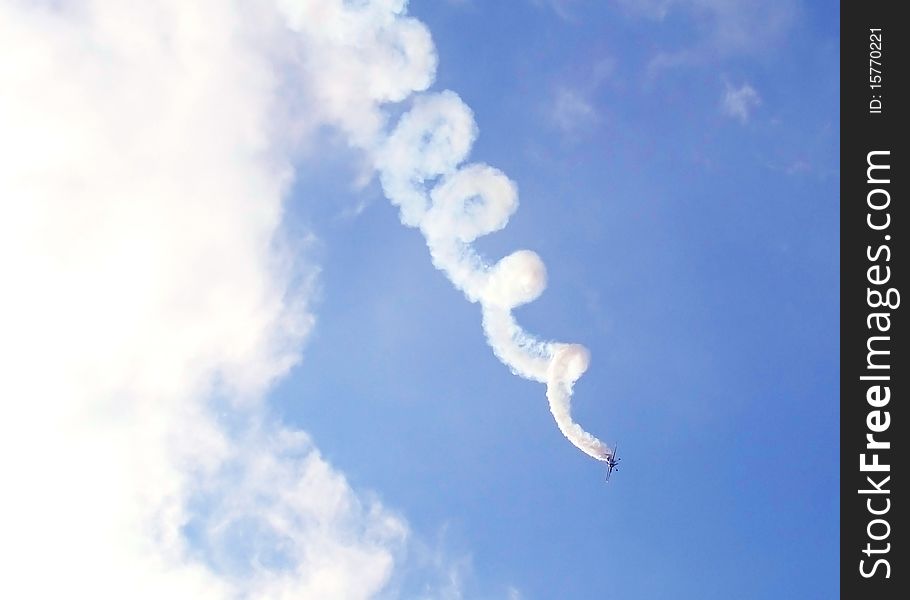 Tailspinning plane on a blue sky. Tailspinning plane on a blue sky.