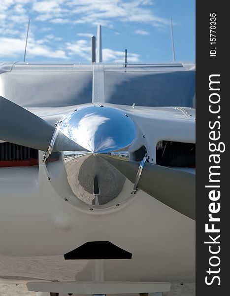 Reflections on a chromed light aircraft propeller nose cone