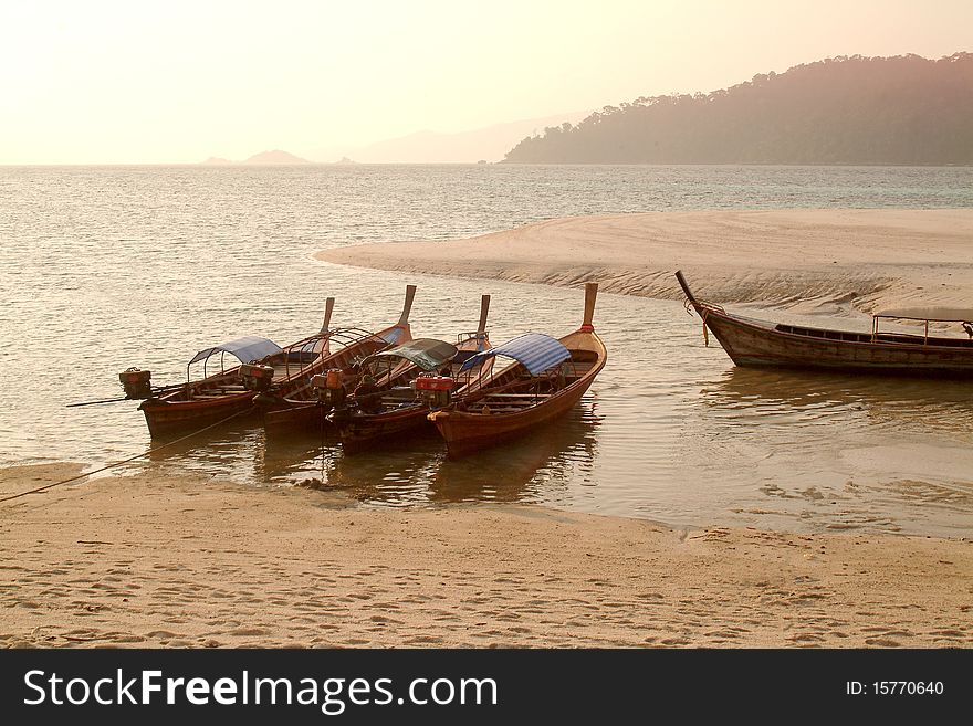 Longtail boat waiting traveller in the Beautiful  beach at Koh Repraw in Tarutao Marine National park , Southern of Thailand. Longtail boat waiting traveller in the Beautiful  beach at Koh Repraw in Tarutao Marine National park , Southern of Thailand