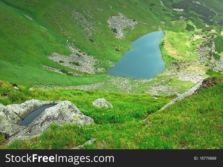 Alpine lake in a green valley